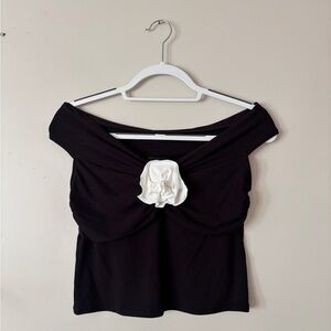 Black Off-Shoulder Top with White Flower Accent